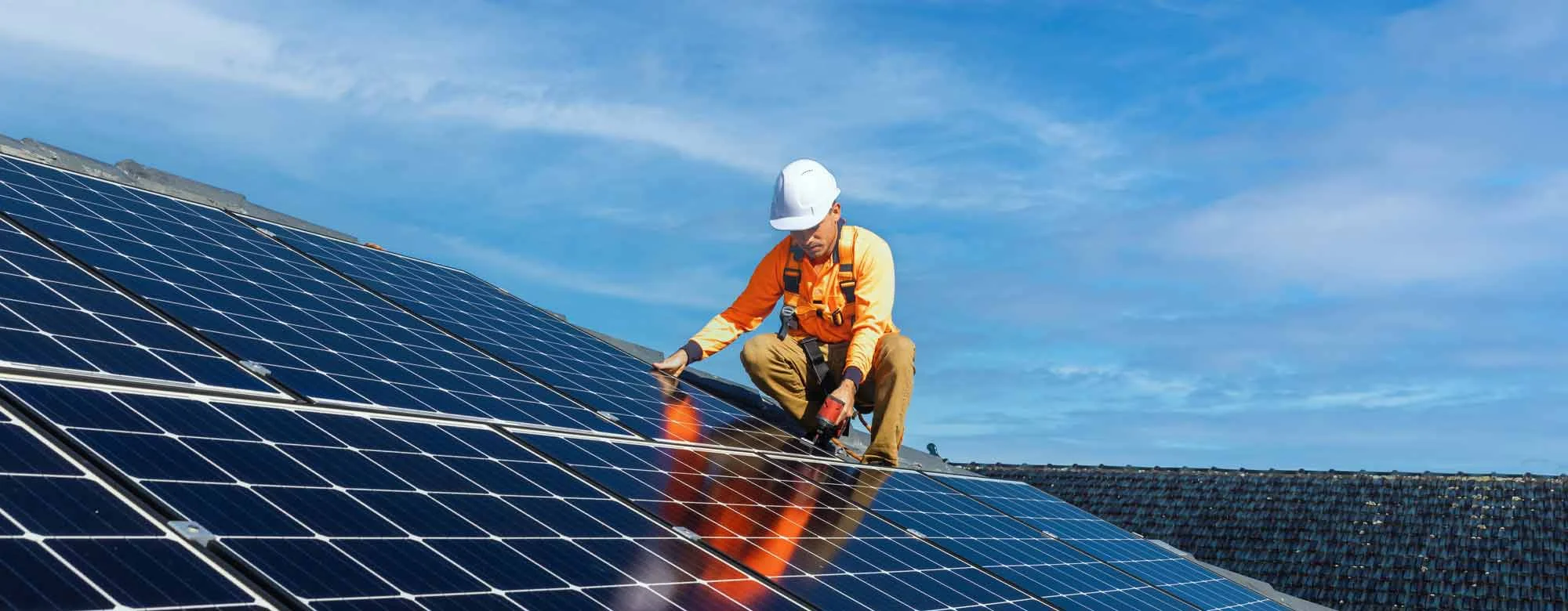 Solar installer on a factory roof