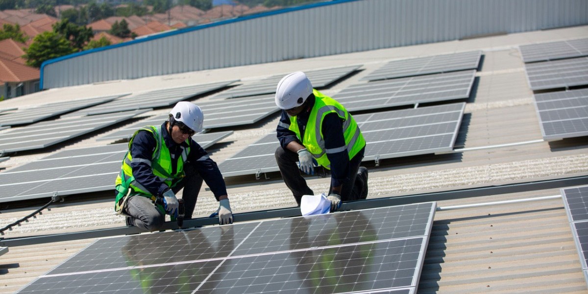 Solar panel installer installing solar panels on roof