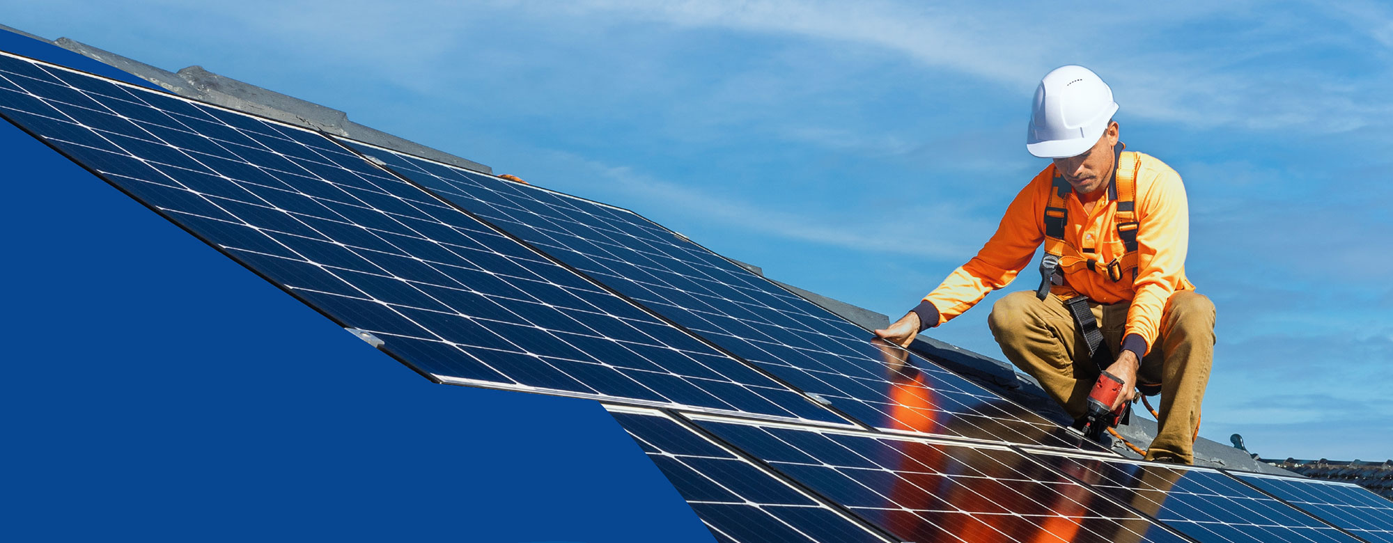 Solar installer on a factory roof